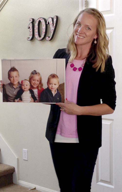 Sister Oscarson's daughter, Abby,  holding a portrait of her children