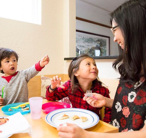 woman and children eating dinner