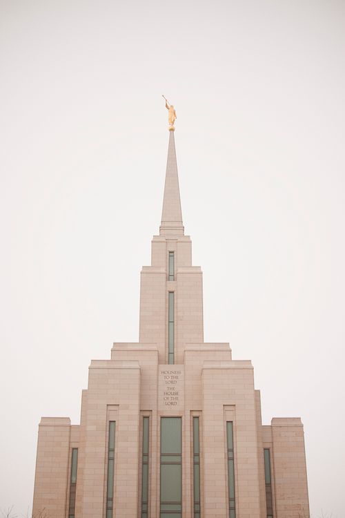 The top half of the front of the Oquirrh Mountain Utah Temple, with a white sky up above.