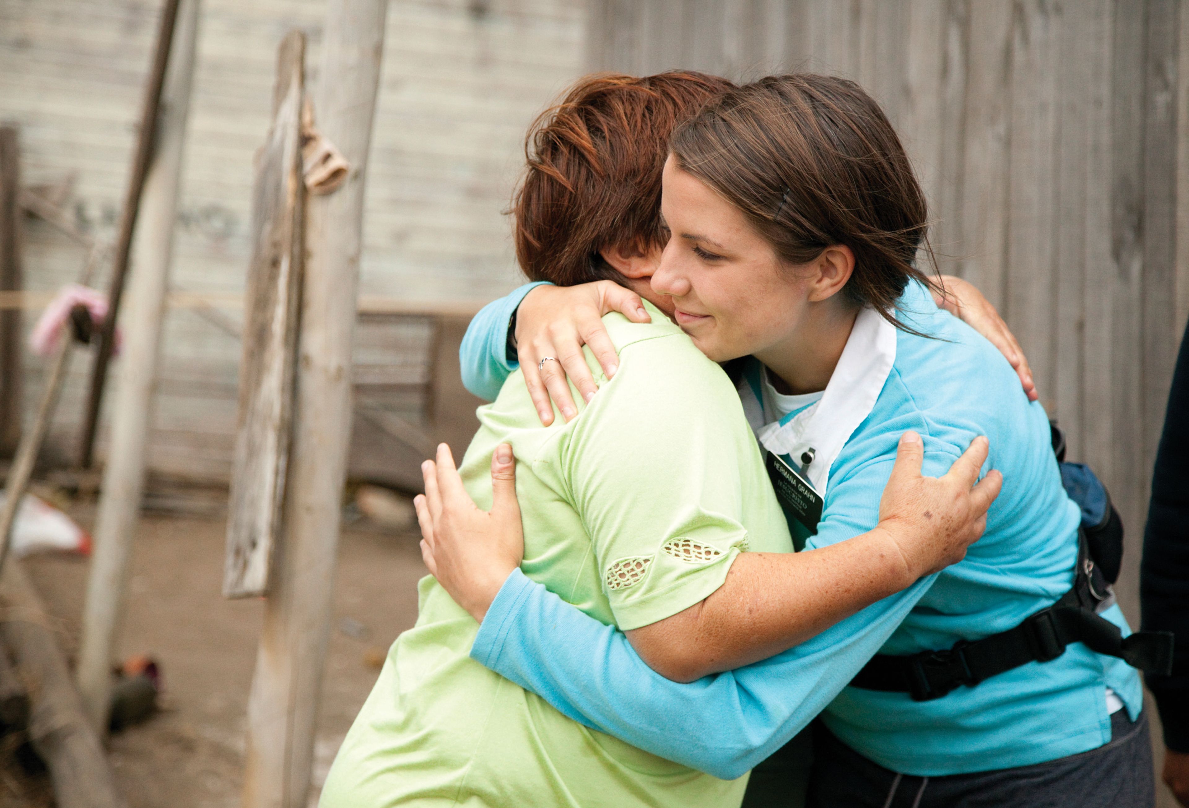 Women embracing during emergency earthquake response efforts in Chile.
