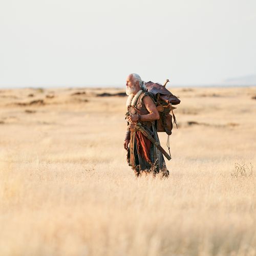 actor portraying Moroni walking alone through a field