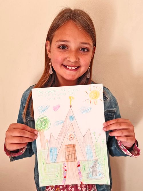 Girl holding drawing of temple