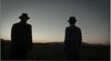 Silhouette of two men