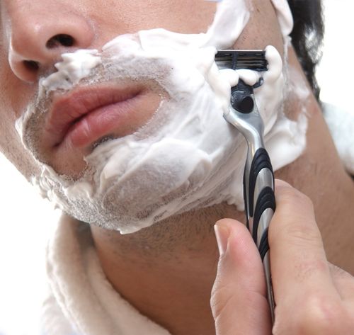 man shaving beard