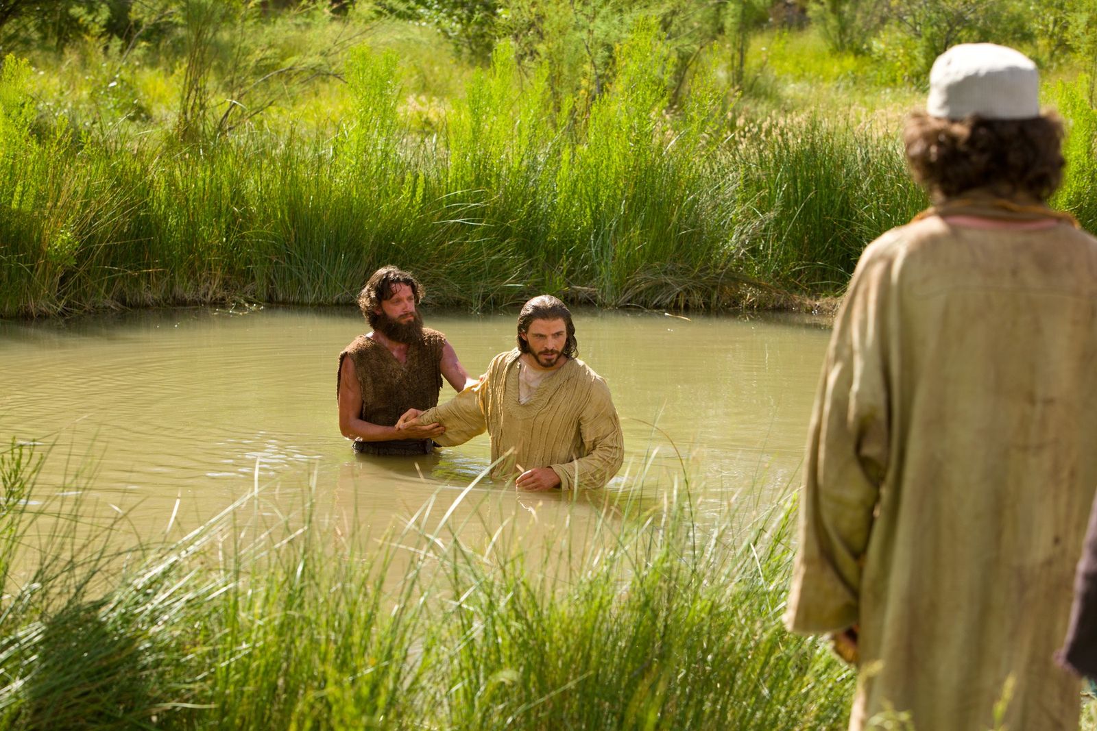 After being baptized, Jesus leaves the waters of Jordan.