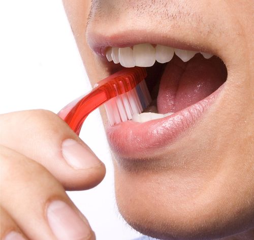 man brushing teeth close-up