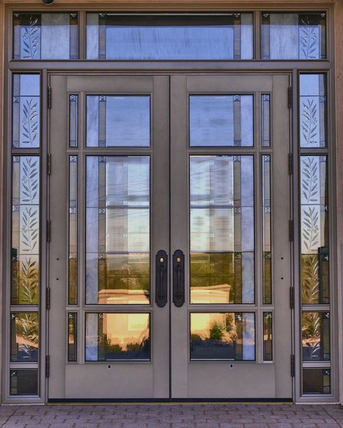 The metal and glass doors on the Kansas City Missouri Temple during the daytime.
