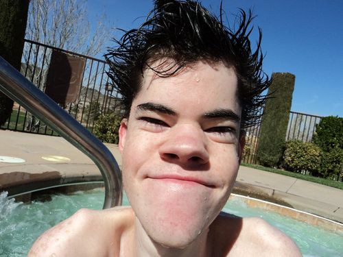 A young man (Jason Christensen) in a swimming pool