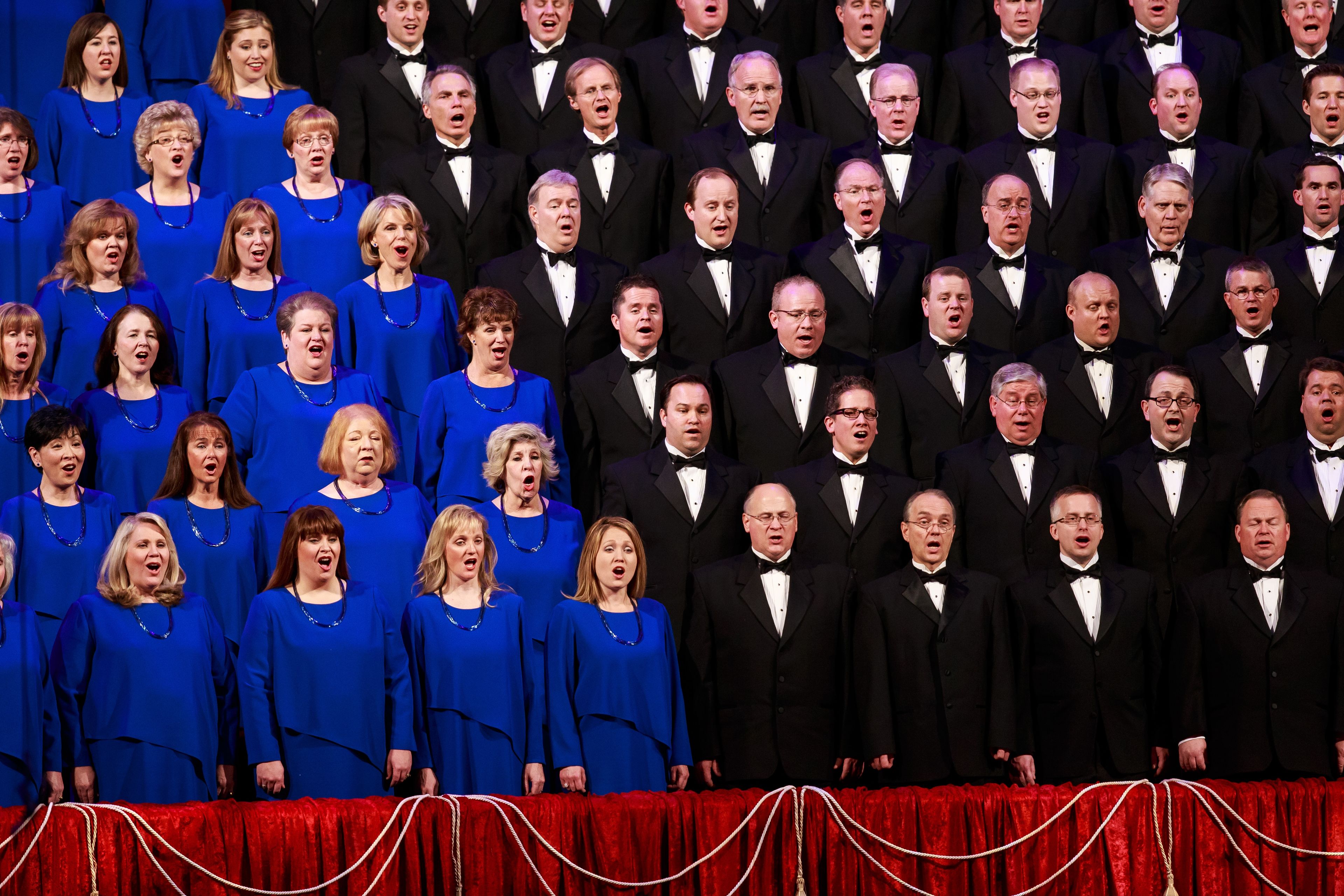 Men and women of the Mormon Tabernacle Choir singing together at the 2013 Christmas concert, featuring Deborah Voigt and John Rhys-Davies.  