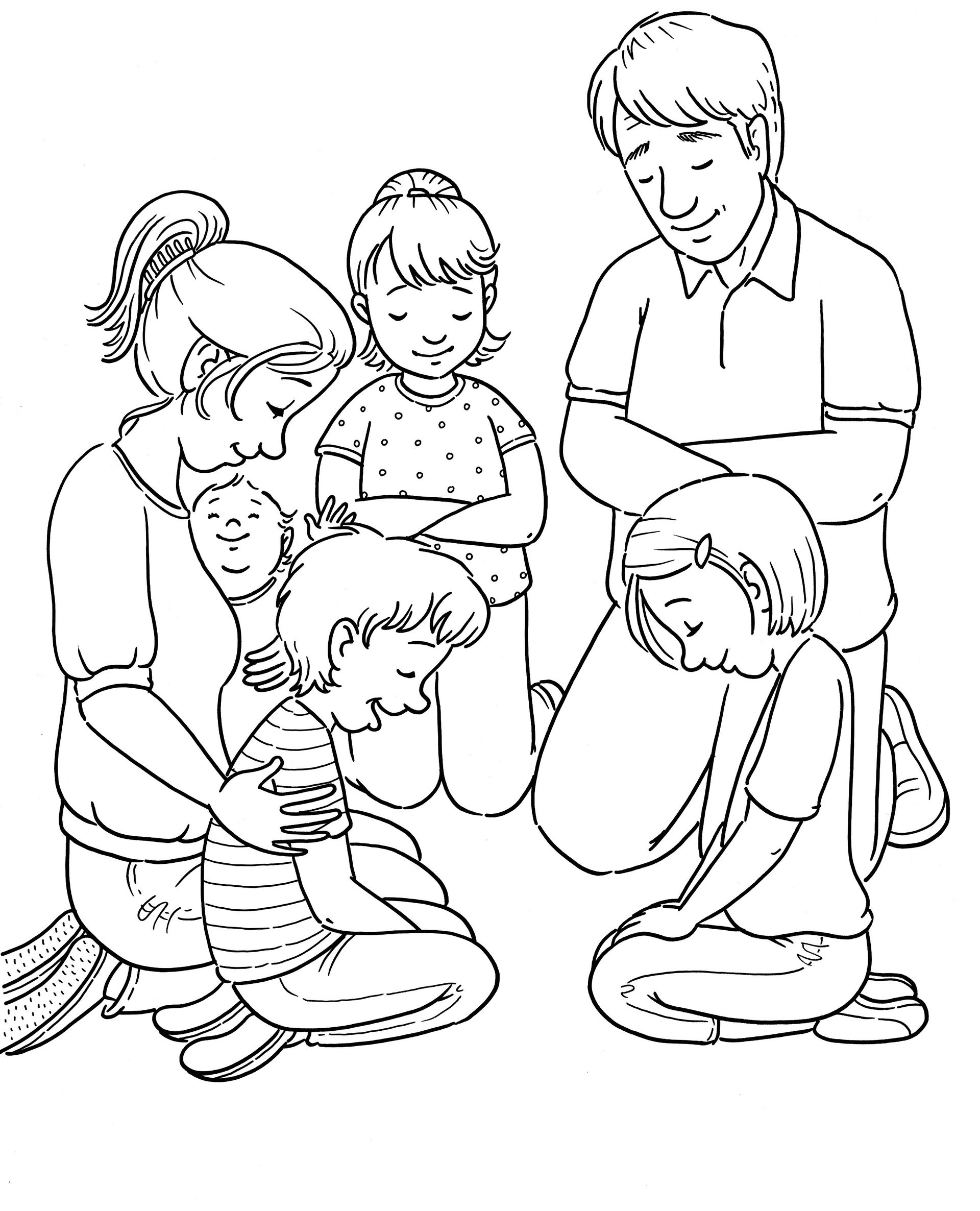 A family kneels in a circle and prays together.