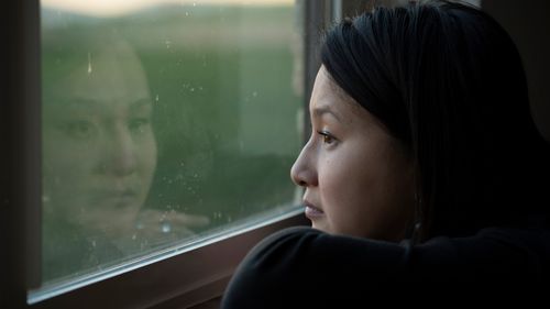 woman looking out a window