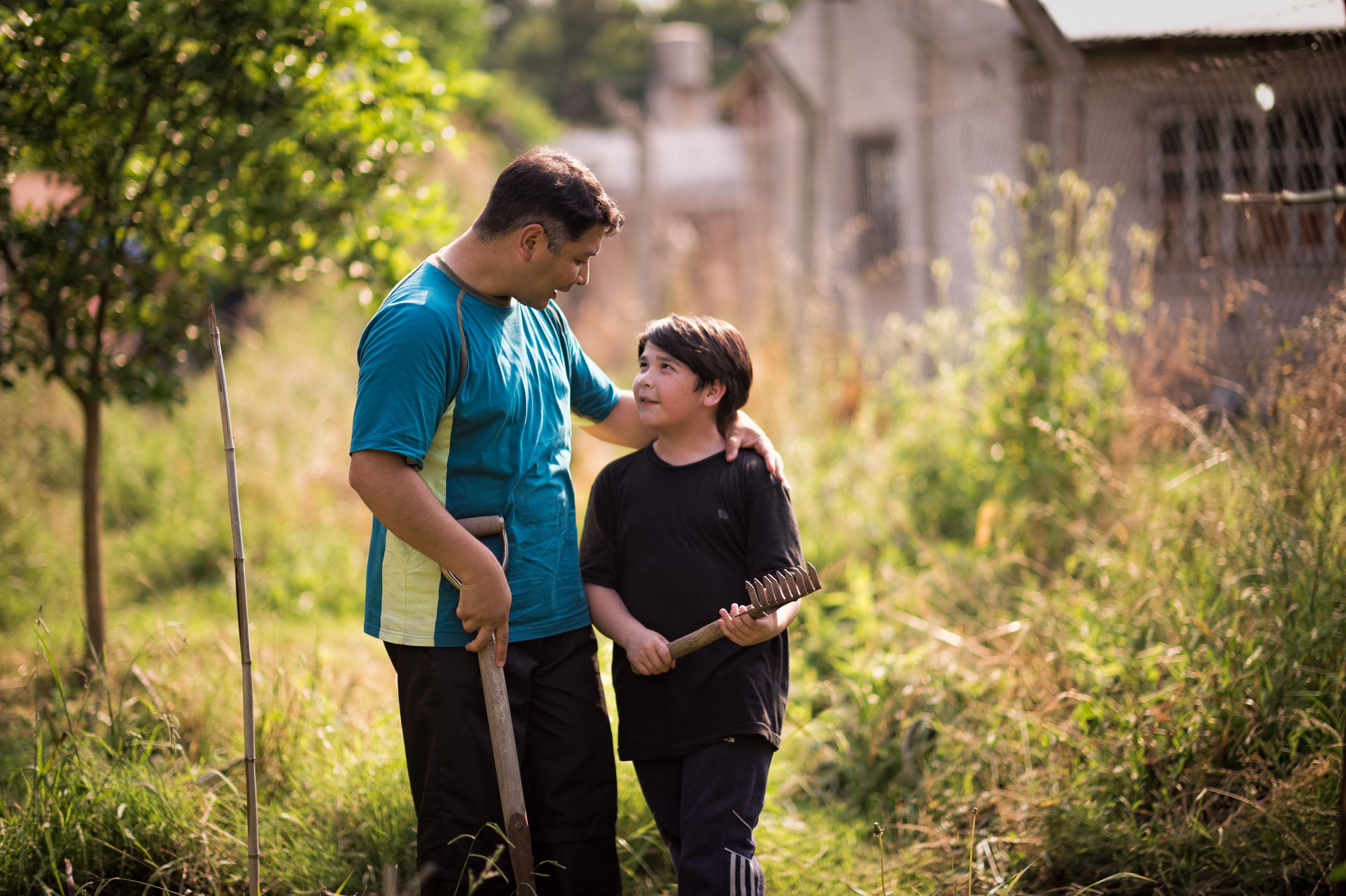 A father and son garden together.