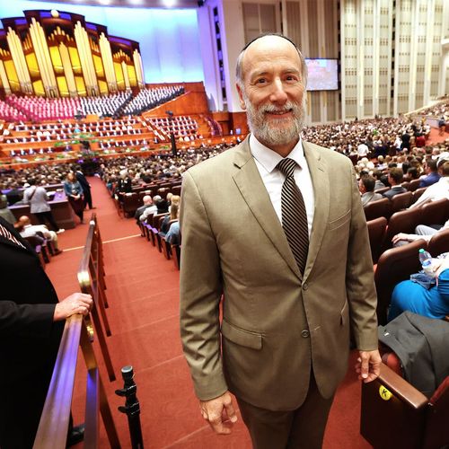 Rabbi Joe standing and smiling in the Conference Center