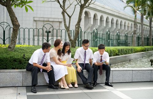 young people gathered outside a temple