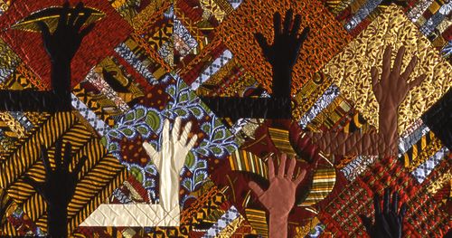 quilt showing hands of many skin colors