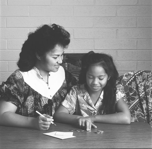 woman and daughter paying tithing