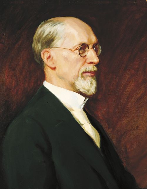 A painted portrait by Lee Greene Richards of President George Albert Smith with a short beard, wearing a black suit and tan tie.