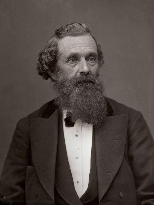 Elder Lorenzo Snow in a vest, suit, and bow tie, with curly hair and a long beard.