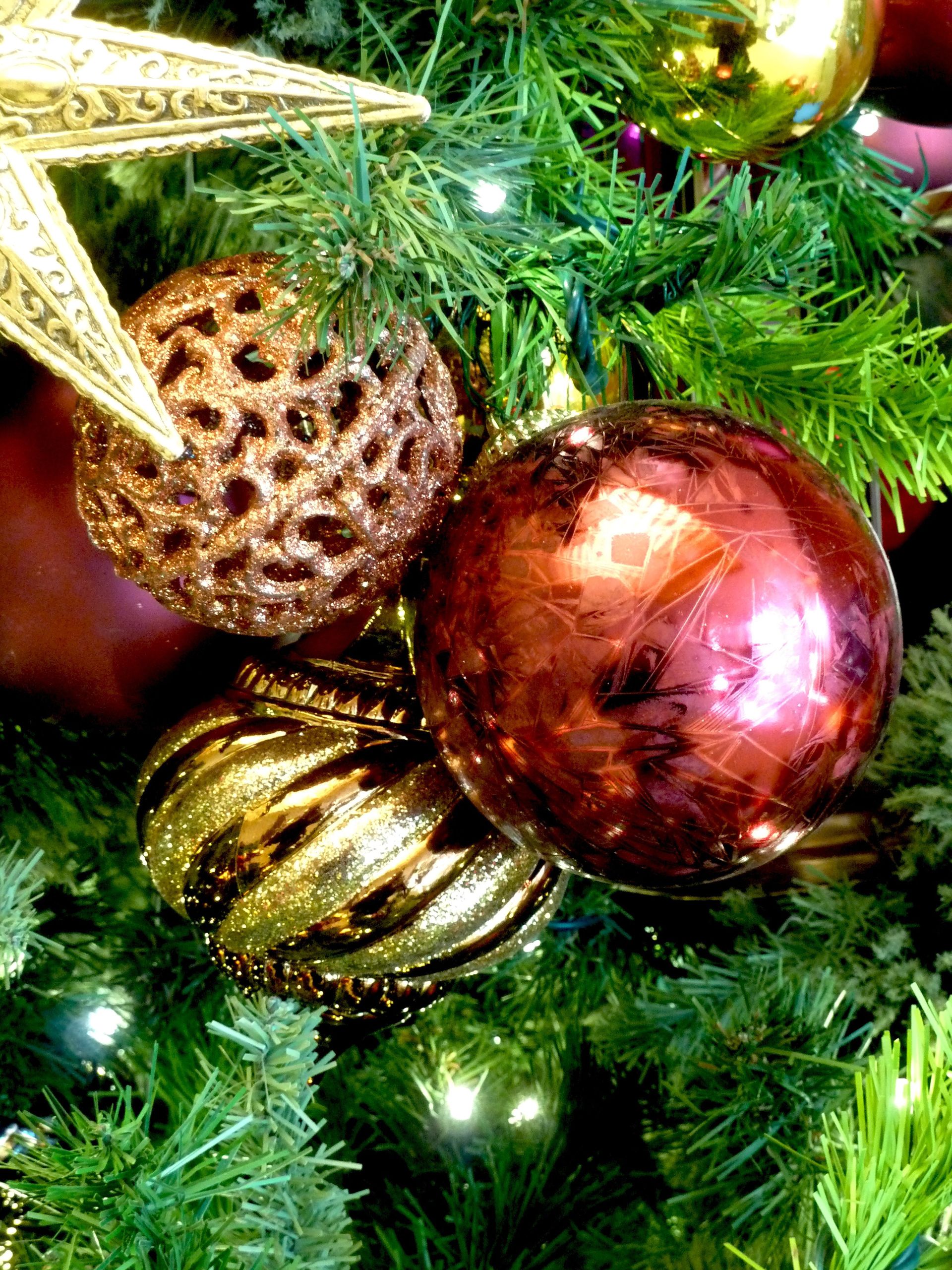 A group of ornaments hanging on a Christmas tree.