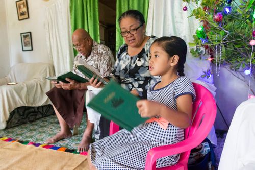 a family singing a hymn together