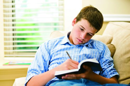 young man marking scriptures