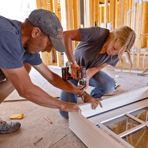 father and daughter working on building a house