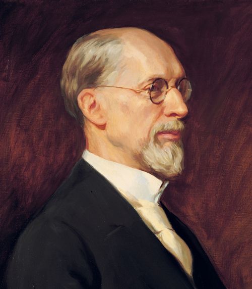 A portrait of the prophet George Albert Smith in a white shirt, a black suit, and glasses.