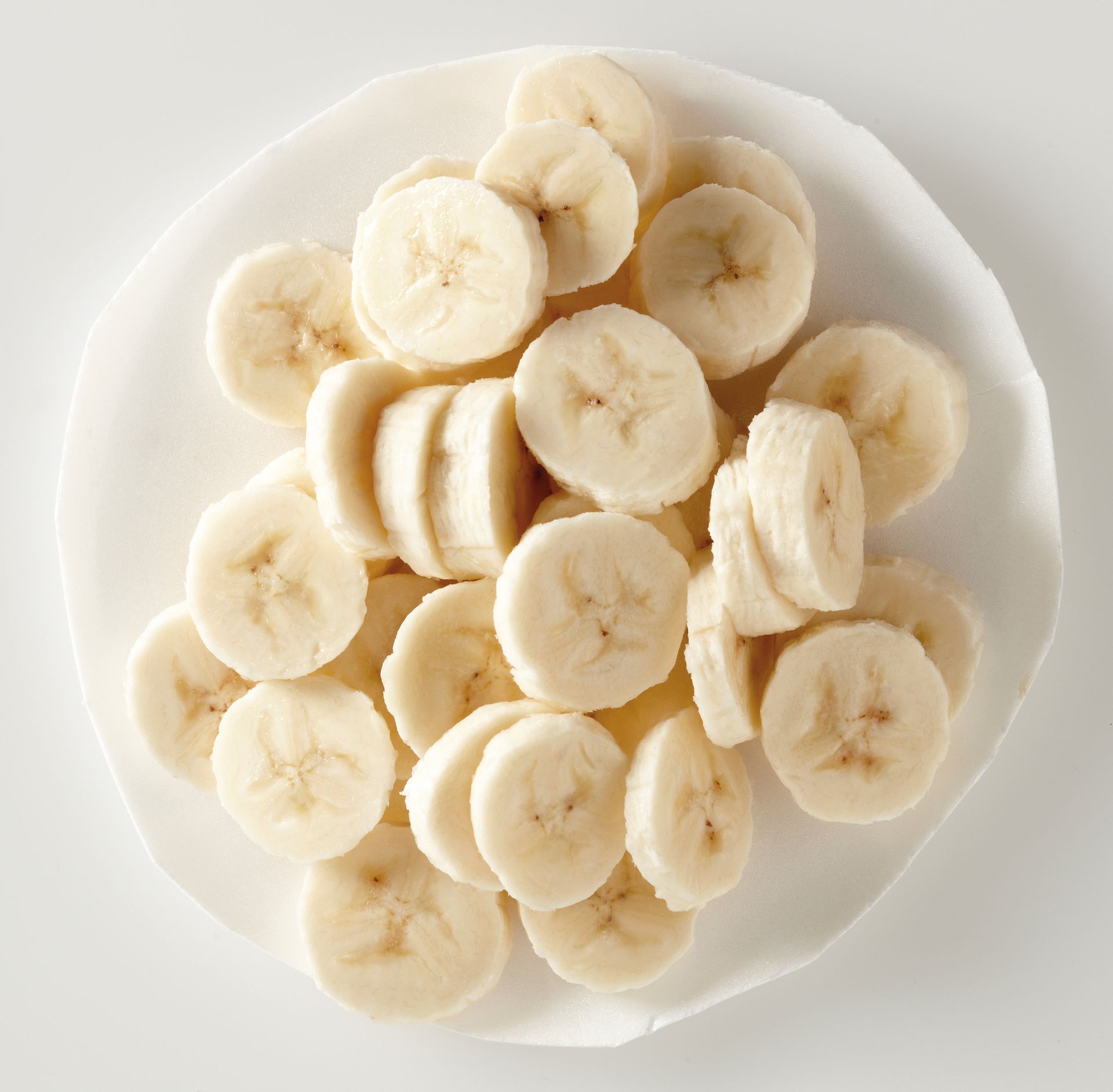 Sliced bananas on a plate.