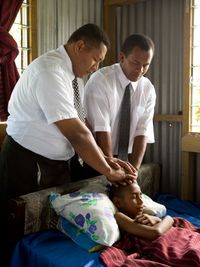 sick girl receiving blessing