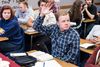 student raising hand in classroom