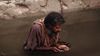 Blind man washing in water