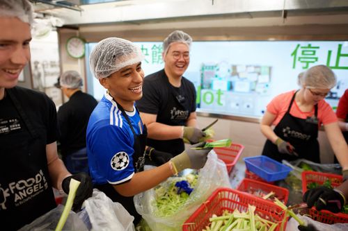 Missionaries helping distribute food during a service project in Hong Kong.