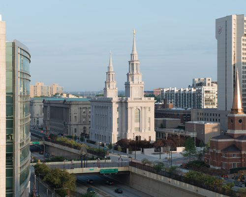 An exterior view of the Philadelphia Pennsylvania Temple and the city's buildings surrounding it.