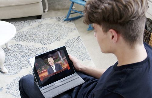Young man watching general conference.