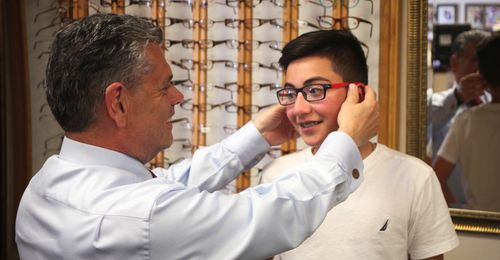 young man being fitted for glasses