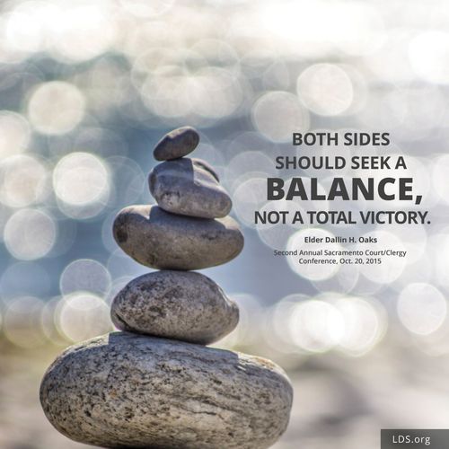 An image of rocks stacked on top of each other with a quote: “Both sides should seek a balance, not a total victory.”