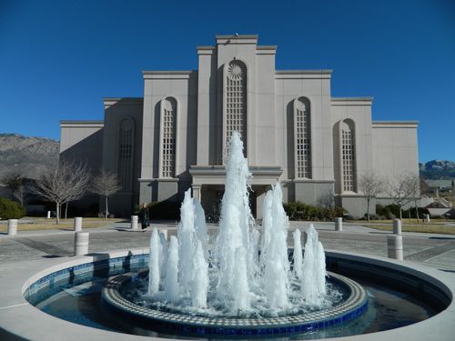 A wide-angle photograph of the water fountain in front of the Albuquerque New Mexico Temple, with the temple seen in the background.