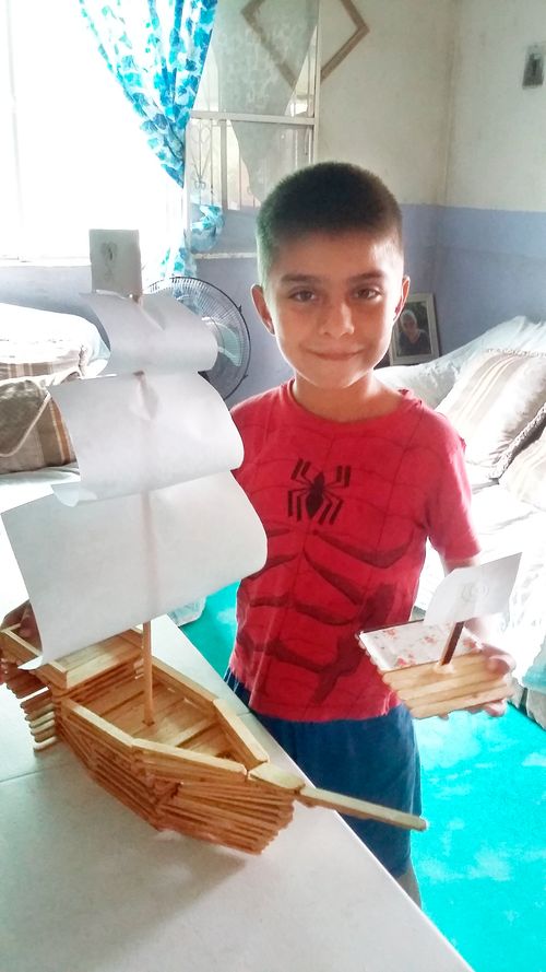 boy with boat he built