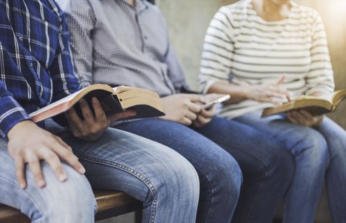 group of people reading scriptures