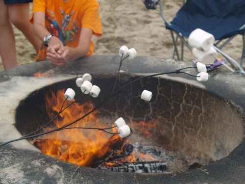 marshmallows roasting over a fire pit