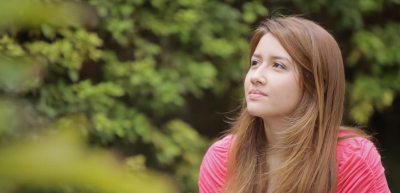 A young woman contemplating plates the blessings of the gospel of Jesus Christ