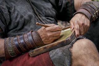 Moroni writing on golden plates