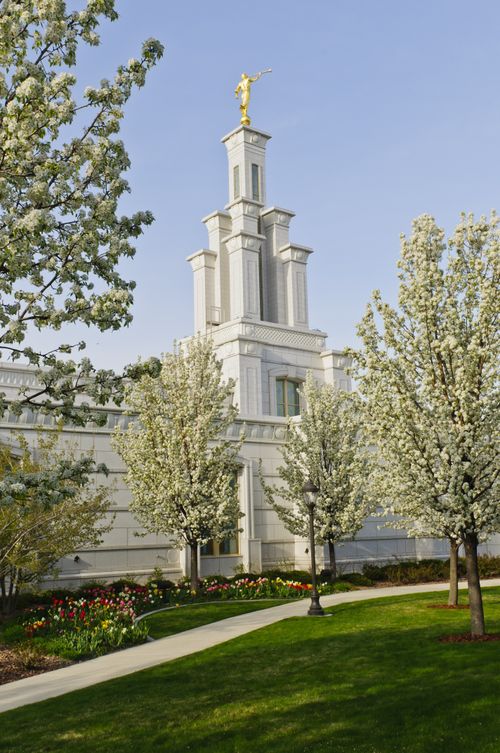 The front of the Columbia River Washington Temple on a spring day, with the trees on the grounds in bloom.