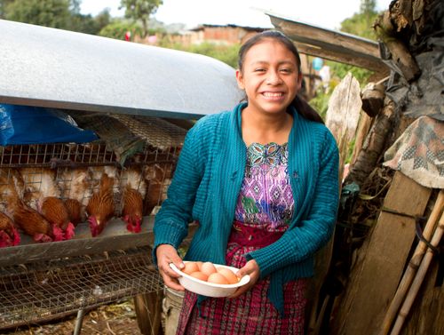 Photo of girl holding bowl of eggs