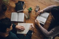 A couple study the Book of Mormon at their kitchen table learning about the gospel of Jesus Christ