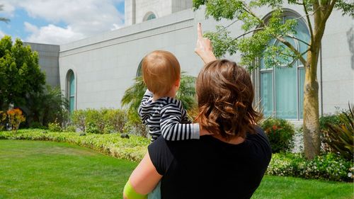 mother showing her baby the temple