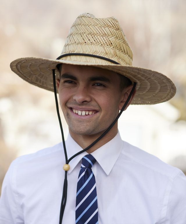Various missionaries model appropriate dress and attire as they look to camera wearing a hat.