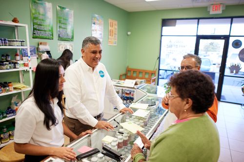 a father and his daughter helping customers