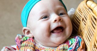 happy baby in basket