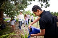 Young man using a watering can